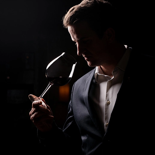 Man smelling a glass of wine at the restaurant Dans le Noir ?